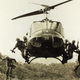 American soldiers leap into a landing zone from a UH-1 “Huey” during the Vietnam War. (San Diego Air and Space Museum)